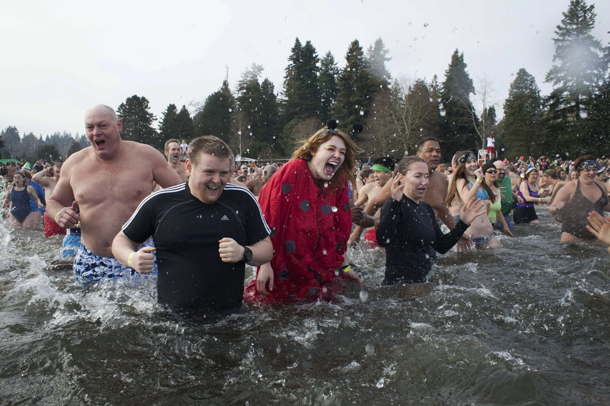 Participants react after entering Lake Washington during the 12th annual Po...