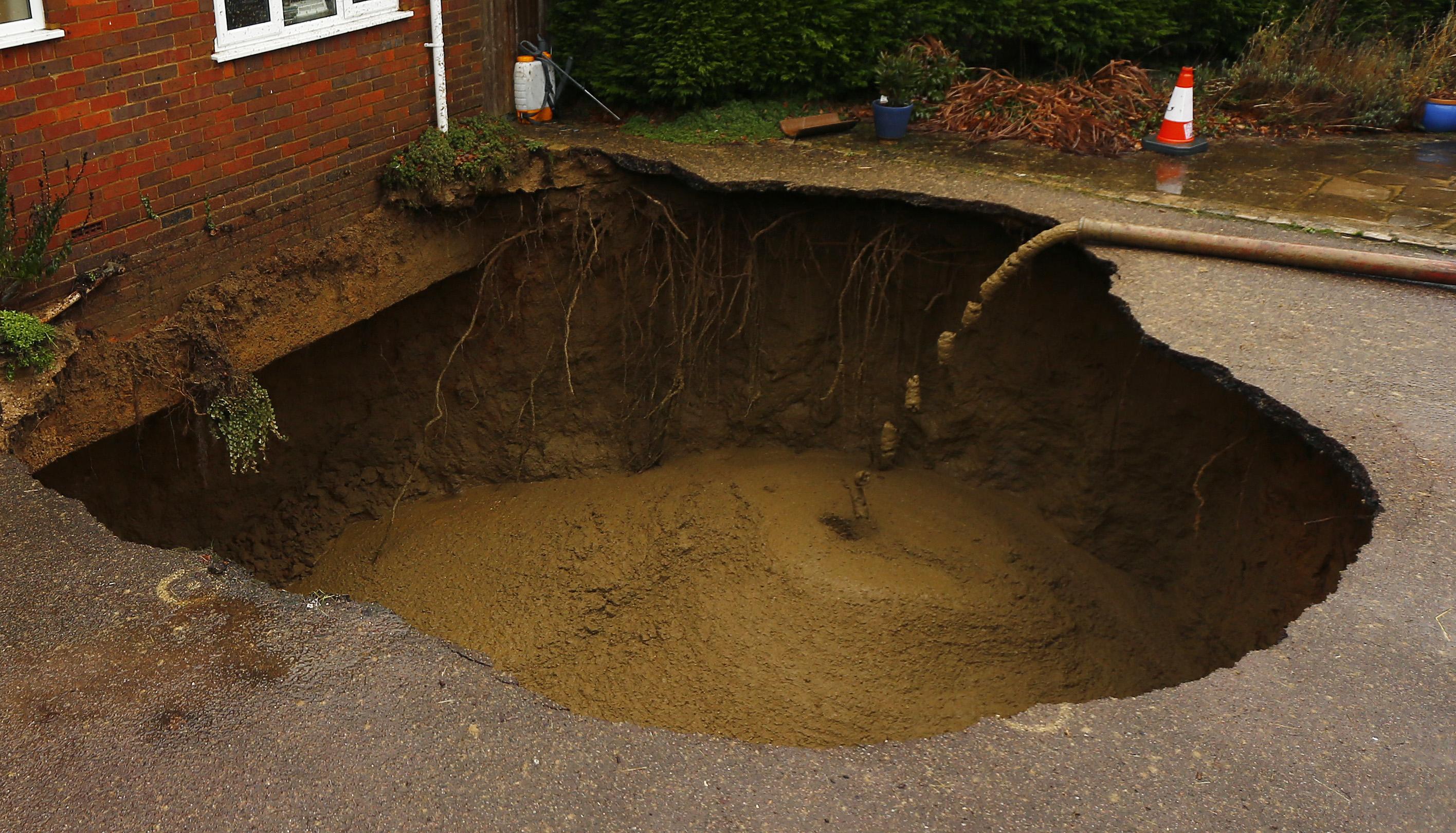 concrete-is-poured-into-4-5-metre-wide-sinkhole-on-the-driveway-of-a