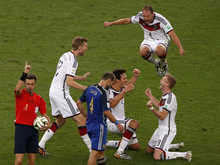 Germany's players celebrate past Argentina's Pablo Zabaleta (3rd L) as referee Nicola Rizzoli (L) of Italy signals the end of the extra time in their 2014 World Cup final at the Maracana stadium in Rio de Janeiro July 13, 2014. (David Gray/Reuters)