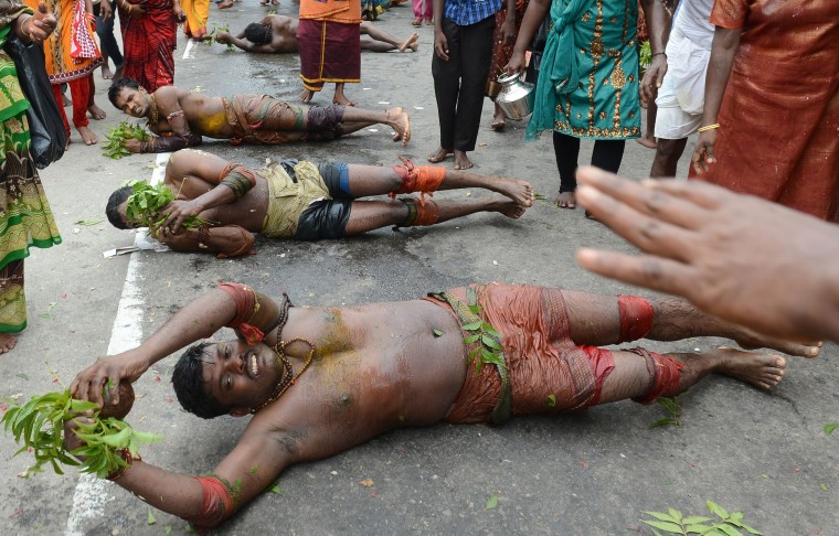 Sri Lankan Tamil Hindu devotees roll on the ground during the Vel Hinduism festival in Colombo. Ethnic Tamils, who are mainly followers of Hinduism, are the main minority community in the island which is emerging from nearly four decades of ethnic conflict which had claimed up to 100,000 lives (Lakruwan Wanniarachchi/AFP-Getty Images)