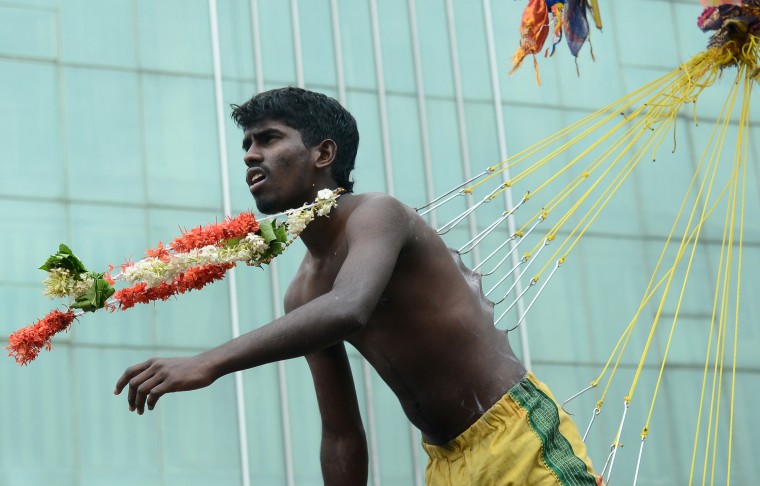 A Sri Lankan Tamil Hindu devotee, seen suspended with hooks pierced through his body, participates in the Vel Hinduism festival in Colombo. Ethnic Tamils, who are mainly followers of Hinduism, are the main minority community in the island which is emerging from nearly four decades of ethnic conflict which had claimed up to 100,000 lives (Lakruwan Wanniarachchi/AFP-Getty Images)