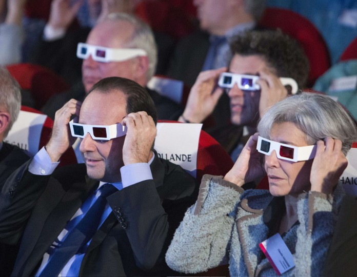 French President Francois Hollande (L) and former French astronaut and minister Claudie Haignere wear 3D glasses to view the first results of the Rosetta mission on the 67P/Churyumov-Gerasimenko comet at the Cite des Sciences in Paris on November 12, 2014. A European probe made the first-ever landing on a comet in a quest to explore the origins of the Solar System, but there were concerns over whether it was fastened securely enough to carry out its mission. (Jacques Brinon/AFP/Getty Images)