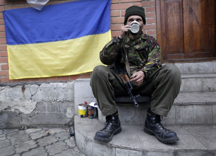 A Ukrainian "Right Sector" volunteer takes a rest at his position near the village of Peski, next to Donetsk's airport on November 13, 2014. The International pressure on Russia was mounting on November 13 over claims it is sending fresh military hardware into eastern Ukraine which could fuel a return to all-out conflict. (Max Vetrov/AFP/Getty Images)
