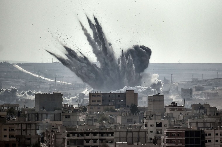 A shell explodes on November 13, 2014 in the Syrian city of Kobane, also known as Ain al-Arab, as seen from the Turkish border village of Mursitpinar, Sanliurfa province. A report issued on November 13 by the Norwegian Refugee Council and International Rescue Committee says Syrians are increasingly unable to escape their country's war as tougher policies in potential host nations are preventing them from taking refuge in the region and beyond. (Aris Messinis/AFP/Getty Images)
