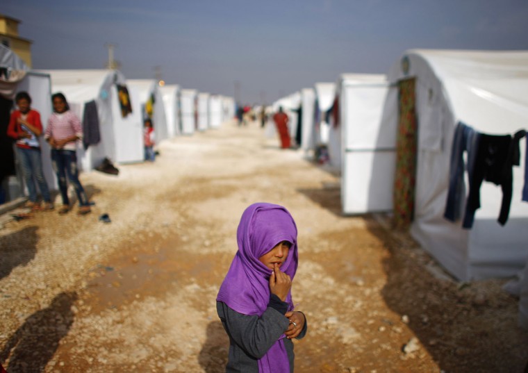A Kurdish refugee girl from the Syrian town of Kobani is seen in a refugee camp in the Turkish border town of Suruc, Sanliurfa province November 13, 2014. (Osman Orsal/Reuters)