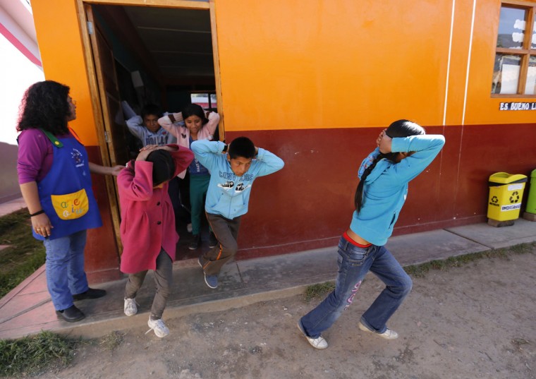 School children evacuate a school during an earthquake and avalanche