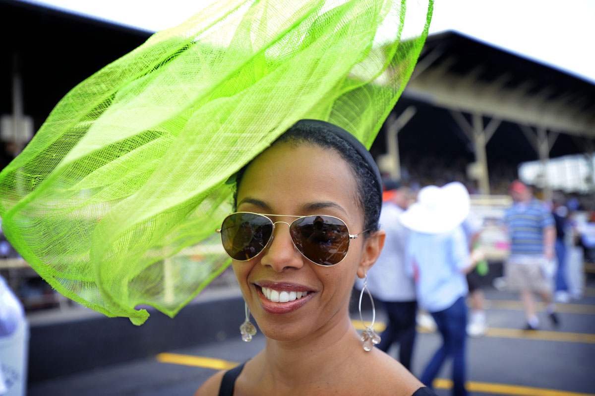 Metti Kanno, Baltimore, MD, attends her 4th Preakness donning a bright green hat. (Robert K. Hamilton/Baltimore Sun) - BS-sp-preakness-p11-hamilto