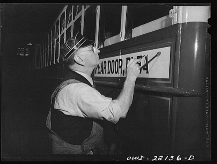 Baltimore, Maryland. Painting a sign on a trolley at the paint shop of the maintenance terminal of the Baltimore Transit Company. (Marjory Collins / April 1943)