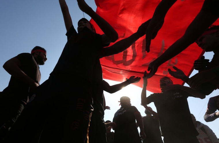 Iraqi Shiite pilgrims flagellate themselves as part of the Arbaeen ritual in Baghdad, Iraq, Sunday, Nov. 29, 2015. (AP Photo/Hadi Mizban)