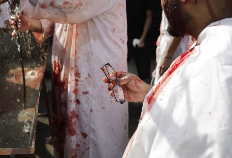 Bahraini Shiite Muslims wash up after flagellating themselves with swords as part of the Arbaeen ritual in Muharraq, Bahrain, Thursday, Dec. 3, 2015. (AP Photo/Hasan Jamali)