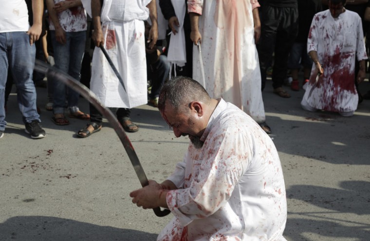 A Bahraini Shiite Muslim flagellates himself with a sword as part of the Arbaeen ritual in Muharraq, Bahrain, Thursday, Dec. 3, 2015. (AP Photo/Hasan Jamali)