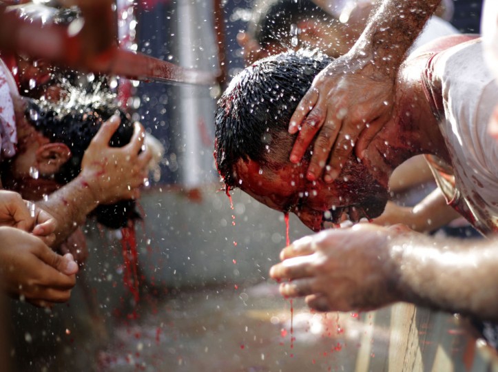 Bahraini Shiite Muslims wash up after flagellating themselves with swords as part of the Arbaeen ritual in Muharraq, Bahrain, Thursday, Dec. 3, 2015. (AP Photo/Hasan Jamali)