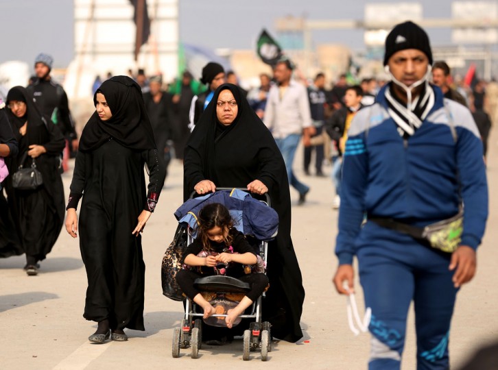 Shiite pilgrims march to Karbala for the Arbaeen ritual in Baghdad, Iraq, Tuesday, Dec.1, 2015. (AP Photo/Hadi Mizban)