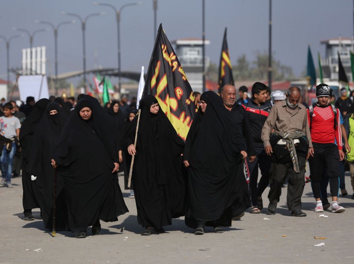 In this Sunday, Nov. 29, 2015, photo, Shiite pilgrims march to Karbala during the Arbaeen ritual in Baghdad, Iraq. Iraqi officials say security was stepped up this year for the millions of pilgrims who descended on the holy city of Karbala to mark the commemoration of Arbaeen Wednesday. (AP Photo/Hadi Mizban)