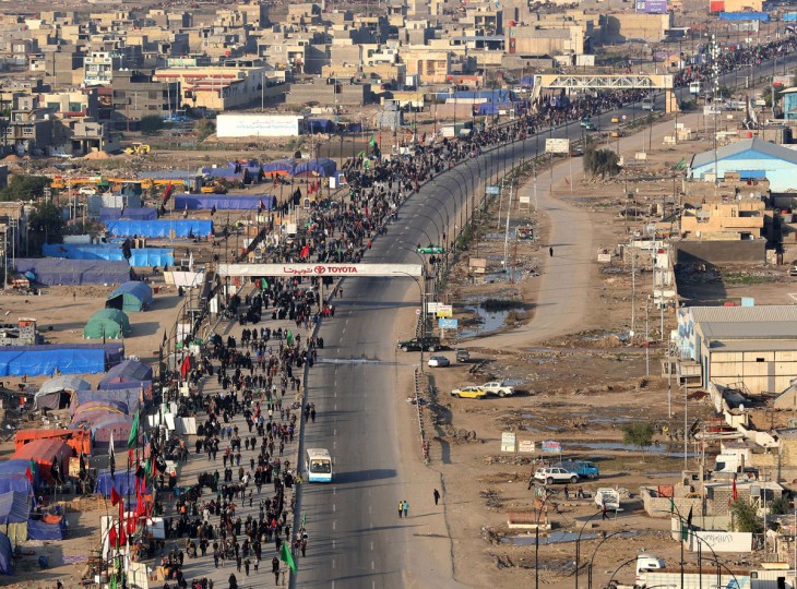 In this Sunday, Nov. 29, 2015, photo, Shiite pilgrims march to Karbala during the Arbaeen ritual in Baghdad, Iraq. Iraqi officials say security was stepped up this year for the millions of pilgrims who descended on the holy city of Karbala to mark the commemoration of Arbaeen Wednesday. (AP Photo/Hadi Mizban)