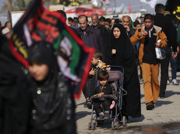 In this Sunday, Nov. 29, 2015, photo, Shiite pilgrims march to Karbala during the Arbaeen ritual in Baghdad, Iraq. Iraqi officials say security was stepped up this year for the millions of pilgrims who descended on the holy city of Karbala to mark the commemoration of Arbaeen Wednesday. (AP Photo/Hadi Mizban)