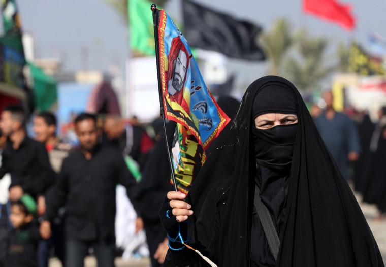 In this Sunday, Nov. 29, 2015, photo, Shiite pilgrims march to Karbala during the Arbaeen ritual in Baghdad, Iraq. Iraqi officials say security was stepped up this year for the millions of pilgrims who descended on the holy city of Karbala to mark the commemoration of Arbaeen Wednesday. (AP Photo/Hadi Mizban)