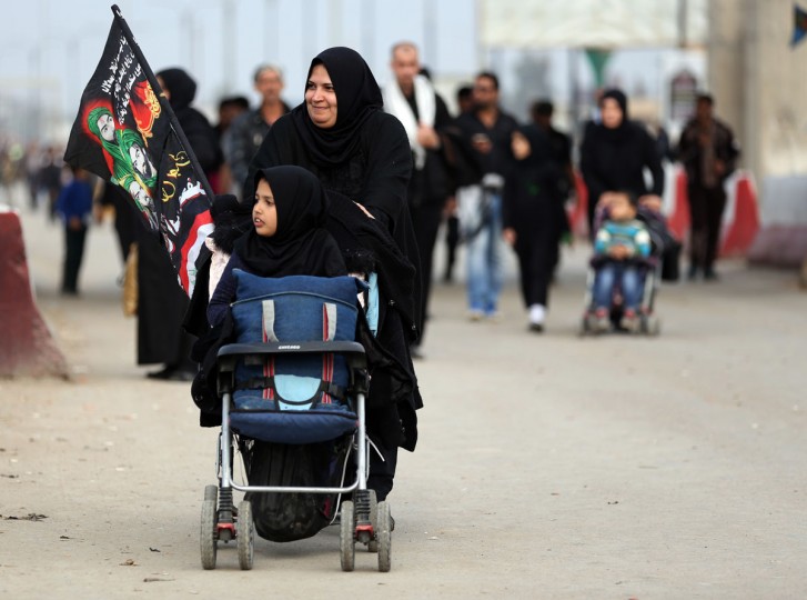 Shiite pilgrims march to Karbala for the Arbaeen ritual in Baghdad, Iraq, Tuesday, Dec. 1, 2015. (AP Photo/Hadi Mizban)