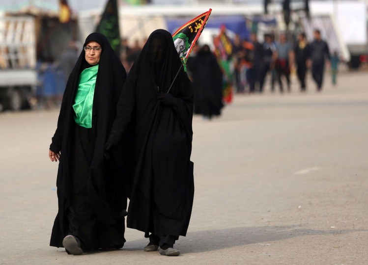 Shiite pilgrims march to Karbala for the Arbaeen ritual in Baghdad, Iraq, Tuesday, Dec. 1, 2015. (AP Photo/Hadi Mizban)