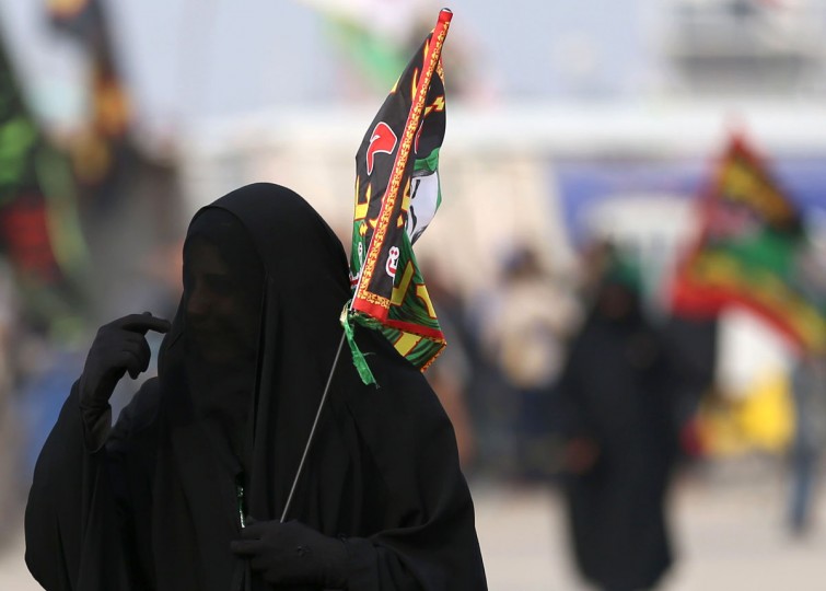 Shiite pilgrims march to Karbala for the Arbaeen ritual in Baghdad, Iraq, Tuesday, Dec. 1, 2015. (AP Photo/Hadi Mizban)