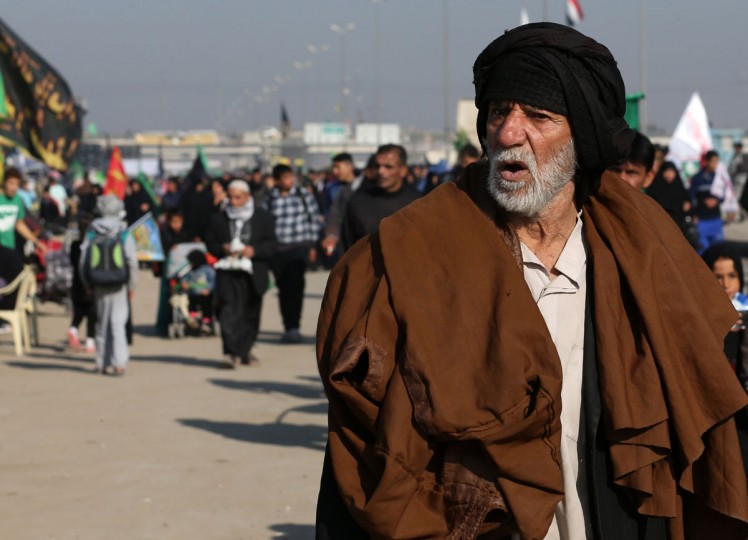 Shiite pilgrims march to Karbala during the Arbaeen ritual in Baghdad, Iraq, Sunday, Nov. 29, 2015. (AP Photo/Hadi Mizban)