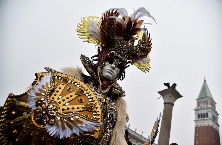 A costumed reveller poses at St Mark's square (Piazza San Marco) during the Venice Carnival in Venice on January 30, 2016. The 2016 edition of the Venice carnival is entitled "Creatum" and runs until February 9th. (Vincenzo Pinto/AFP/Getty Images)