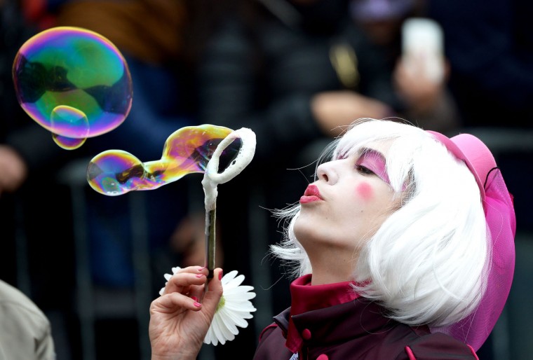 A costumed reveller blows bubbles while waiting for the performance of the "Angel flight" or "Flight of the dove" from the bell tower of Saint Mark's square (Piazza San Marco) to officially launch the Venice Carnival on January 31, 2016. The 2016 edition of the Venice carnival has for theme "Creatum" and runs until February 9. (Vincenzo Pinto/AFP/Getty Images)