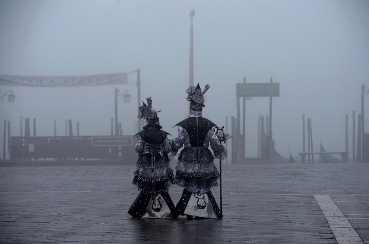 Revellers in costumes arrive to attend the performance of the "Angel flight" or "Flight of the dove" from the bell tower of Saint Mark's square (Piazza San Marco) to officially launch the Venice Carnival on January 31, 2016. The 2016 edition of the Venice carnival has for theme "Creatum" and runs until February 9. (Vincenzo Pinto/AFP/Getty Images)