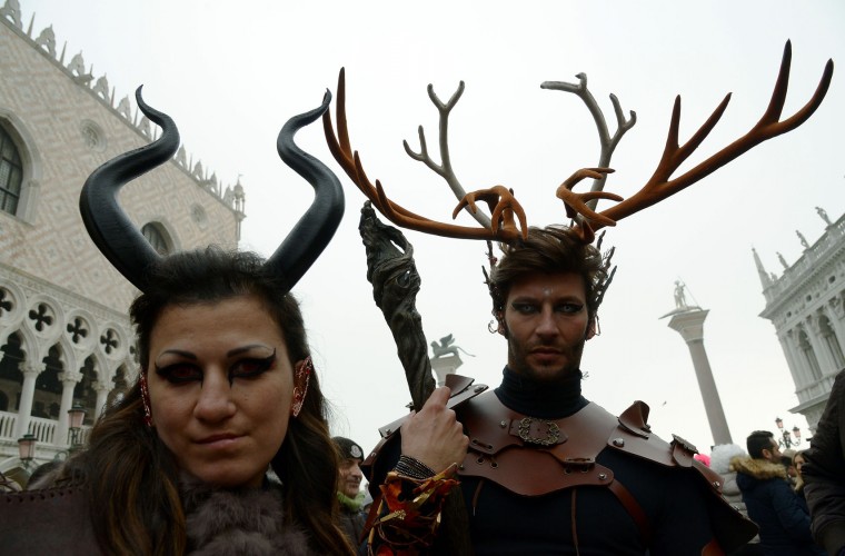 Costumed revellers pose in St Mark's square (Piazza San Marco) after the officially launch of the Venice Carnival on January 31, 2016 in Venice. The 2016 edition of the Venice carnival is untitled "Creatum" and runs until February 9th. (Vincenzo Pinto/AFP/Getty Images)