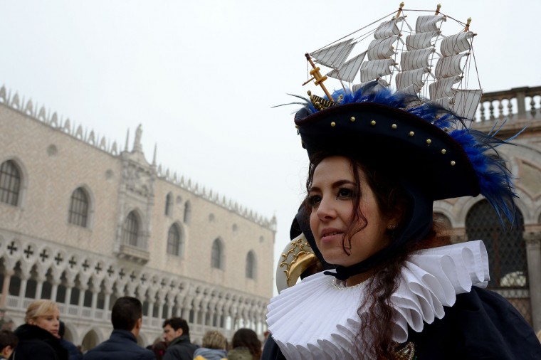 Costumed reveller poses in St Mark's square (Piazza San Marco) after the officially launch of the Venice Carnival on January 31, 2016 in Venice. The 2016 edition of the Venice carnival is untitled "Creatum" and runs until February 9th. (Vincenzo Pinto/AFP/Getty Images)