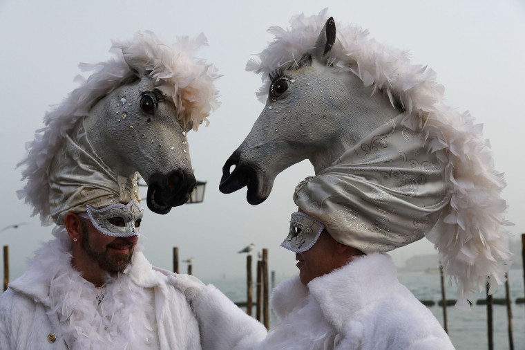 Costumed revellers pose in St Mark's square (Piazza San Marco) after the officially launch of the Venice Carnival on January 31, 2016 in Venice. The 2016 edition of the Venice carnival is untitled "Creatum " and runs until February 9th. (Vincenzo Pinto/AFP/Getty Images)