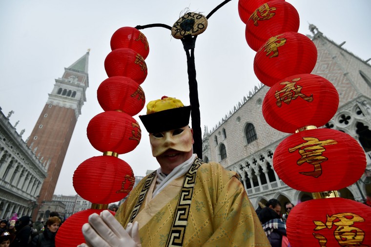 Costumed reveller walks in St Mark's square (Piazza San Marco) after the officially launch of the Venice Carnival on January 31, 2016 in Venice. The 2016 edition of the Venice carnival is untitled "Creatum" and runs until February 9th. (Vincenzo Pinto/AFP/Getty Images)