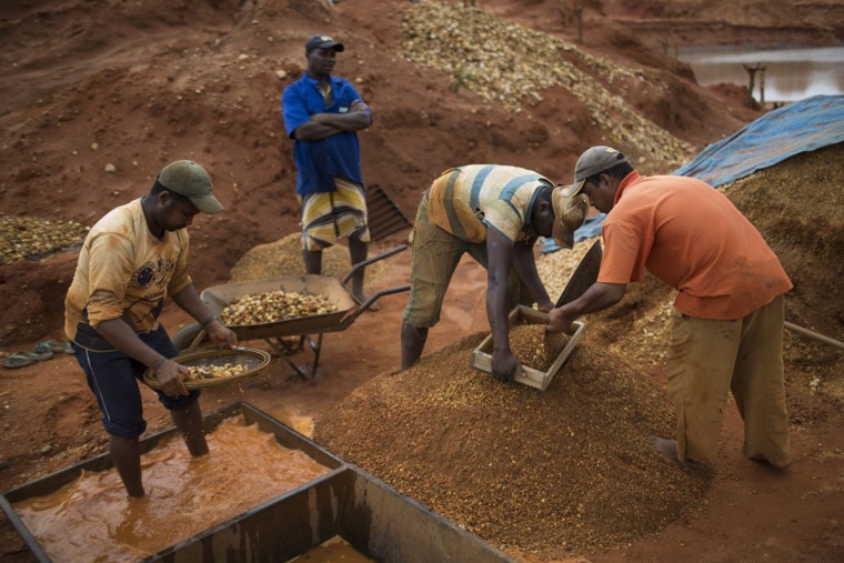 In this Nov. 17, 2015 photo, artisanal miners separate gravel with sieves as they search for diamonds at an abandoned mine in Areinha, Minas Gerais state, Brazil. During the weeks-long mining process, the group excavates the soil down to a layer of gravel of up to 50 meters (yards) deep. (AP Photo/Felipe Dana)