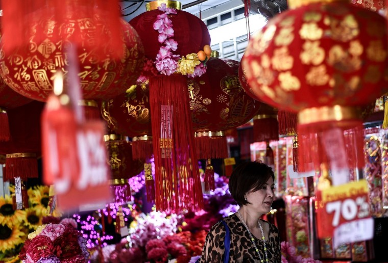 An Ethnic Malaysian-Chinese woman checks out decorations at a shop in Kuala Lumpur's popular Chinatown on February 5, 2016 ahead of the Lunar New Year celebrations. The Lunar New Year will mark the start of the year of the monkey on February 8. (Manan Vatsyayana/AFP/Getty Images)