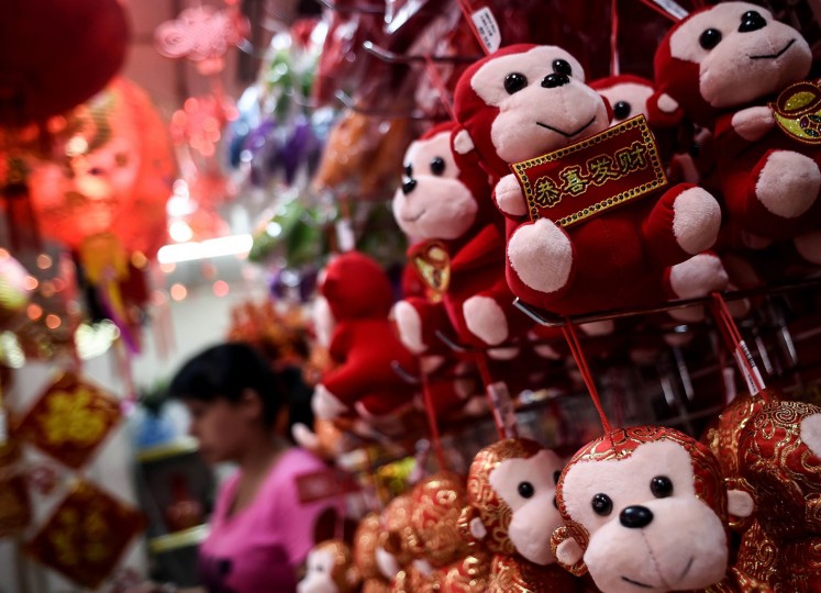 A shopkeeper walk past monkey soft-toys at a shop in Kuala Lumpur's popular Chinatown on February 5, 2016 ahead of the Lunar New Year celebrations. The Lunar New Year will mark the start of the year of the monkey on February 8. (Manan Vatsyayana/AFP/Getty Images)