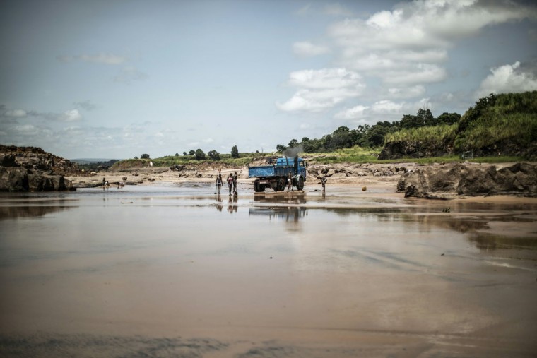 Sand diggers are seen loading trucks at a quarry on the banks of the Congo river in the Kombe district of Brazzaville on March 28, 2016. (MARCO LONGARI/AFP/Getty Images)