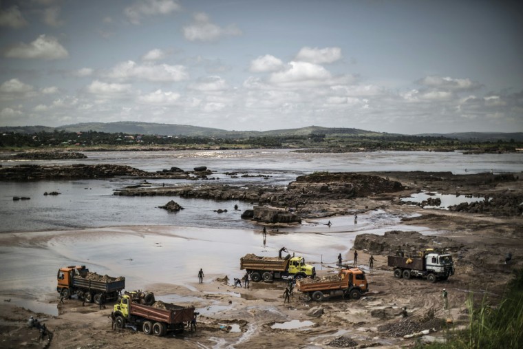 Sand diggers are seen loading trucks at a quarry on the banks of the Congo river in the Kombe district of Brazzaville on March 28, 2016. (MARCO LONGARI/AFP/Getty Images)