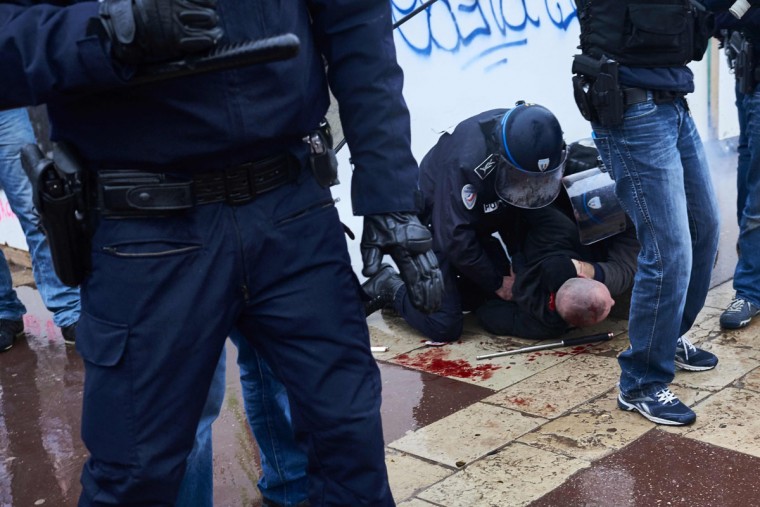 Police detain a protester during clashes at a demonstration on March 9, 2016, in Lyon, central-eastern France, as part of a nationwide day of protest against proposed labour reforms. France faced a wave of protests on March 9 against deeply unpopular labour reforms that have divided an already-fractured Socialist government and raised hackles in a country accustomed to iron-clad job security. (AFP / Jean-Philippe Ksiazek)
