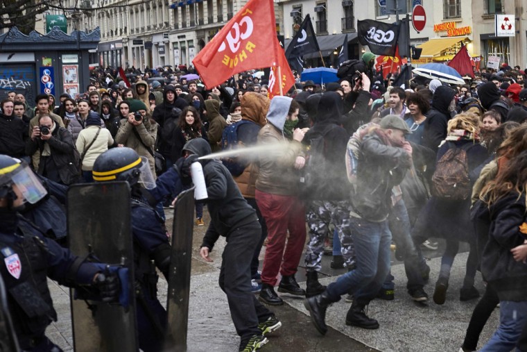 Police fire tear gas at protesters during a demonstration on March 9, 2016, in Lyon, central-eastern France, as part of a nationwide day of protest against proposed labour reforms. France faced a wave of protests on March 9 against deeply unpopular labour reforms that have divided an already-fractured Socialist government and raised hackles in a country accustomed to iron-clad job security. A protester clashes with police during a demonstration on March 9, 2016, in Lyon, central-eastern France, as part of a nationwide day of protest against proposed labour reforms. France faced a wave of protests on March 9 against deeply unpopular labour reforms that have divided an already-fractured Socialist government and raised hackles in a country accustomed to iron-clad job security. (AFP / Jean-Philippe Ksiazek)