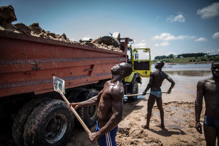 Sand diggers are seen loading trucks at a quarry on the banks of the Congo river in the Kombe district of Brazzaville on March 28, 2016. (MARCO LONGARI/AFP/Getty Images)