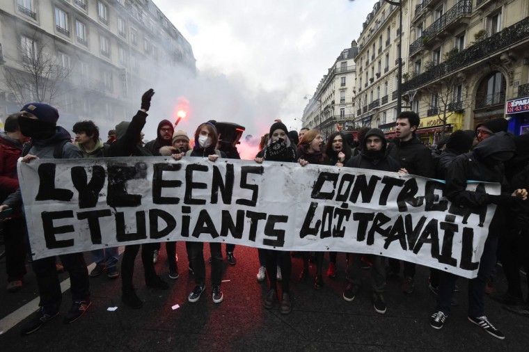 Demonstrators protest against the labour reforms on March 9, 2016 in Paris. The placard reads : "Higgh school pupils, students, against labour reforms". France faced a wave of protests on March 9, 2016, against deeply unpopular labour reforms, that have divided an already fractured Socialist government and roised hackles in a country accustomed to iron-clad job security. (AFP Photo / Dominique Faget)