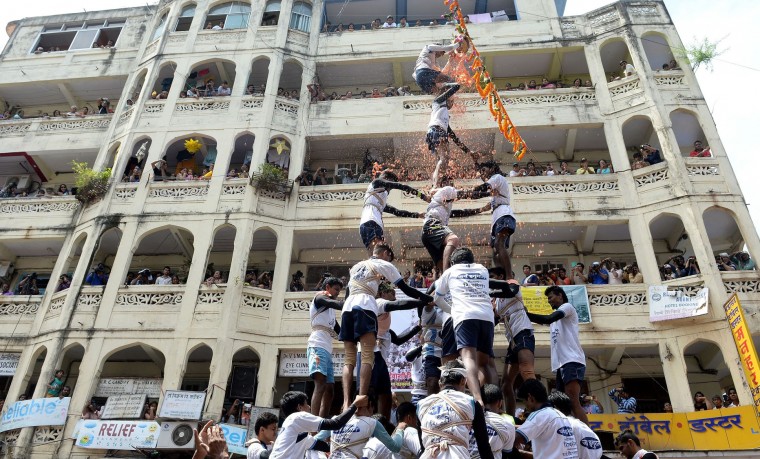 FILE - This file photograph taken on September 6, 2015 shows Indian Hindu devotees as they form a human pyramid in a bid to reach and break a dahi-handi (curd-pot) suspended in the air during celebrations for the Janmashtami festival, which marks the birth of Hindu God Lord Krishna in Mumbai. India's top court on August 17, 2016, has banned children from taking part in a popular but potentially dangerous religious festival in the country's west that sees young boys scale human pyramids. The Supreme Court barred children aged under 18 from scaling the pyramids and restricted their height to 20 feet (six metres) following a string of accidents in recent years. (Indranil Mukherjee/AFP/Getty Images)