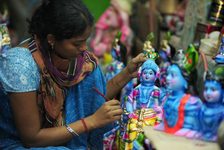 A Indian woman worker gives the finishing touches to an idol of Hindu god Krishna at a workshop in Chennai on August 20, 2016. The birthday of Indian Hindu God Krishna will be celebrated as 'Krishna Janmashtami' by Hindus all over world on August 25. (Arun Sankar/AFP/Getty Images)
