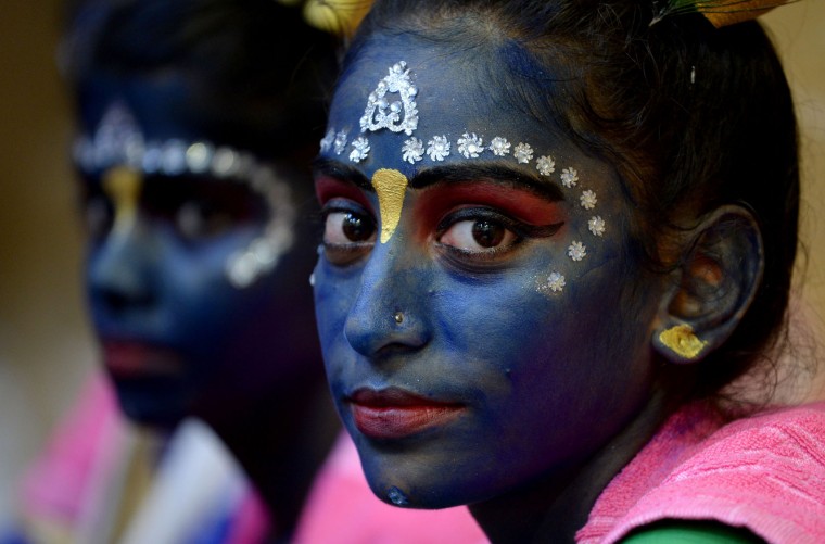 Indian participants dressed as the Hindu god Lord Krishna wait for the start of a cultural event in the run up to the dahi handi (curd pot) celebrations of 'Janmashtami', which mark the birth of Lord Krishna, in Mumbai on August 23, 2016. India's top court on August 17, 2016, has banned children from taking part in a popular but potentially dangerous religious festival in the country's west that sees young boys scale human pyramids. The Supreme Court barred children aged under 18 from scaling the pyramids and restricted their height to 20 feet (six metres) following a string of accidents in recent years. (Indranil Mukherjee/AFP/Getty Images)