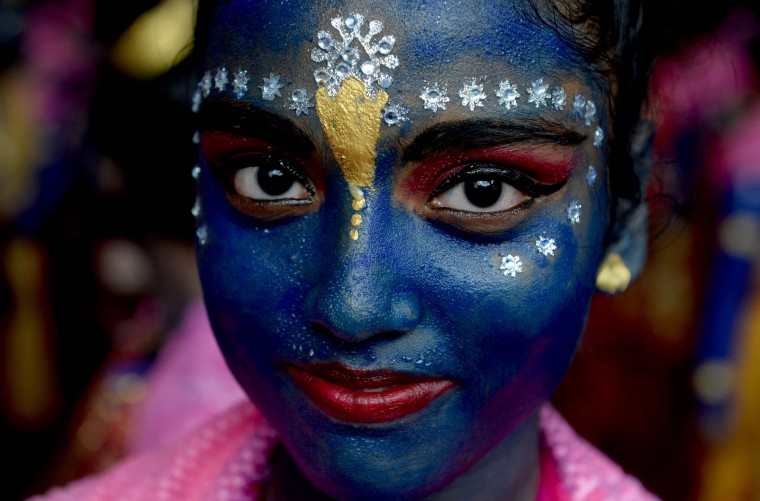 An Indian participant dressed as the Hindu god Lord Krishna looks on during a cultural event in the run up to the dahi handi (curd pot) celebrations of 'Janmashtami', which mark the birth of Lord Krishna, in Mumbai on August 23, 2016. India's top court on August 17, 2016, has banned children from taking part in a popular but potentially dangerous religious festival in the country's west that sees young boys scale human pyramids. The Supreme Court barred children aged under 18 from scaling the pyramids and restricted their height to 20 feet (six metres) following a string of accidents in recent years. (Indranil Mukherjee/AFP/Getty Images)