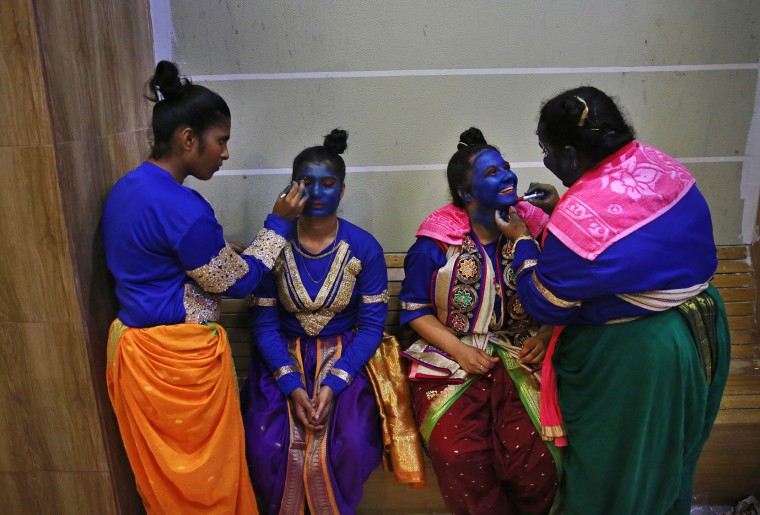 Indian students get their faces painted in blue color as they prepare for Janmashtami celebrations at a college in Mumbai, India, Tuesday, Aug. 23, 2016. Janmashtami, is an annual celebration of the birth of the Hindu deity Krishna. (AP Photo/Rafiq Maqbool)