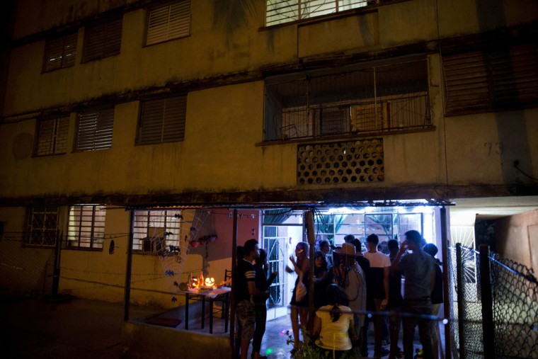 Youth gather for a Halloween party in Havana, Cuba, Friday, Oct. 28, 2016. The costume party was held in the ground-floor apartment of a Soviet-era housing project in Cuba's capital. (AP Photo/Ramon Espinosa)