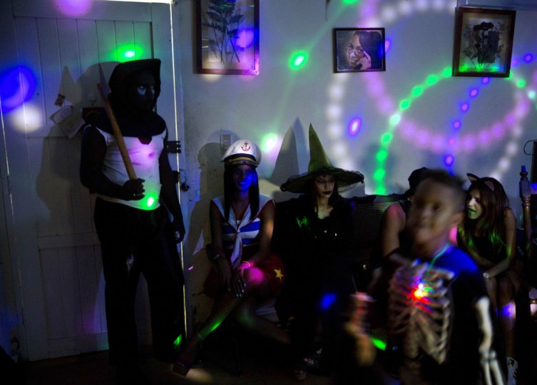 Youth in costumes attend a Halloween party at a home in Havana, Cuba, Friday, Oct. 28, 2016. The costumes ranged from expensive imported rented outfits to handmade costumes cobbled together from items found around the house. (AP Photo/Ramon Espinosa)