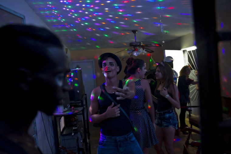 Youth in costume dance at a Halloween party at a residence in Havana, Cuba, Friday, Oct. 28, 2016. The rising popularity of Halloween is one of many manifestations of the decades-long intermingling of Cuban and U.S. culture despite the half-century of hostility between the two countries‚Äô governments. (AP Photo/Ramon Espinosa)